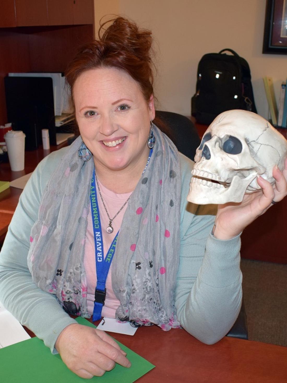 Craven CC Criminal Justice program instructor LauraAnn Avery, holding class prop “Fred the Head,” recently became the program coordinator and is helping retain its award-winning status.
