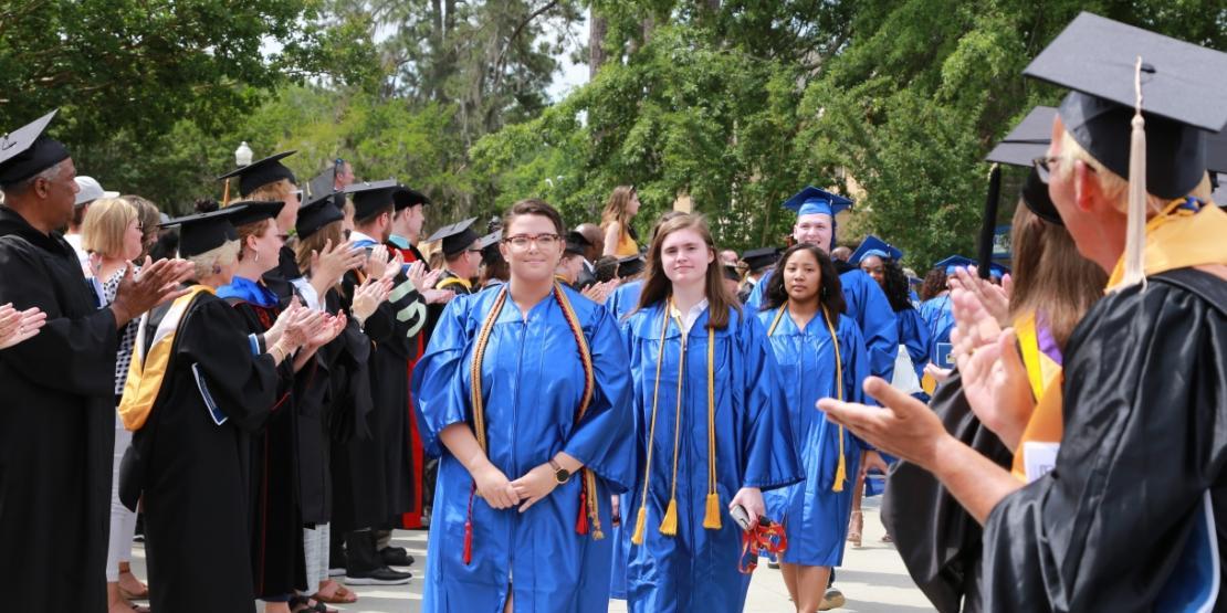 Faculty and staff applaud a procession of Craven CC graduates, led by Chief Marshall Paige Fike. The college’s 52nd commencement ceremony was held Saturday, May 11 on the New Bern campus. 