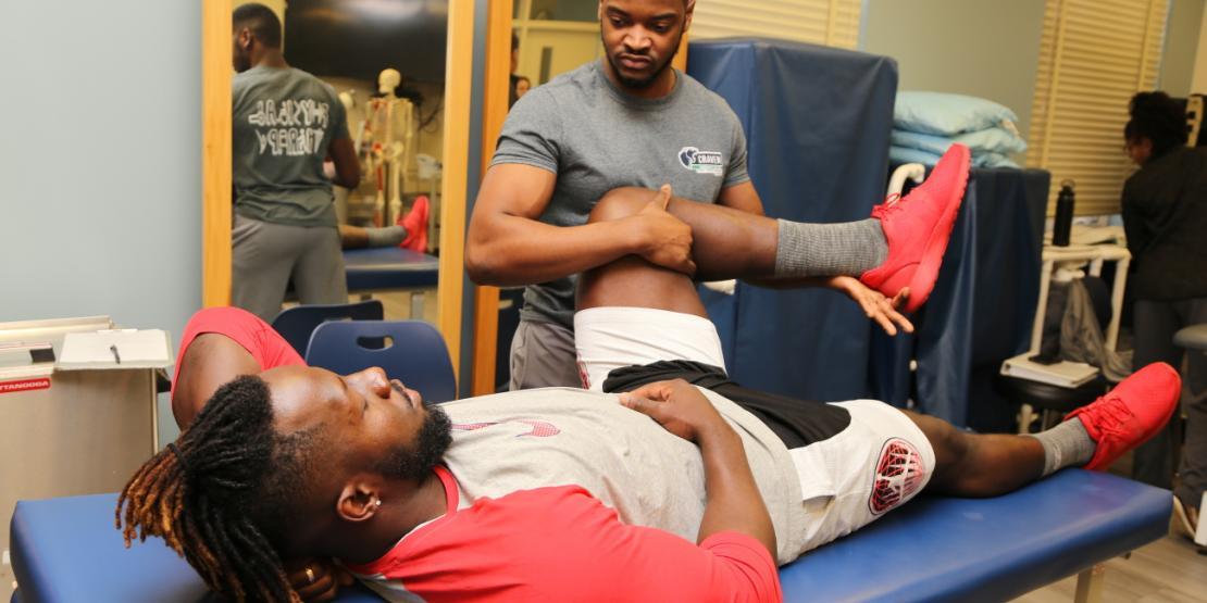 Craven CC Physical Therapist Assistant (PTA) program student Omar Howell performs a strengthening intervention on fellow student Tevin Meda. The PTA program is one of three health programs accepting applications through April 30. 