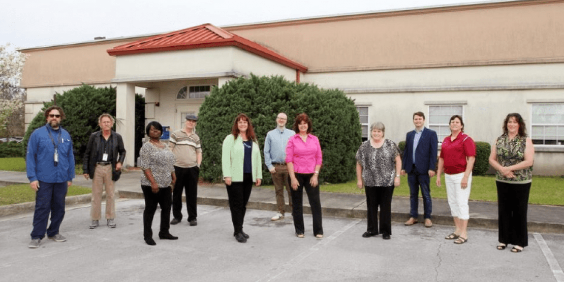 New Bern Sun Journal newspaper staff stand socially distanced outside facility