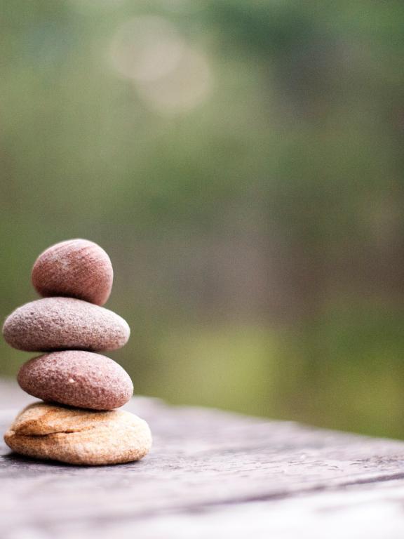 Four small stones balancing
