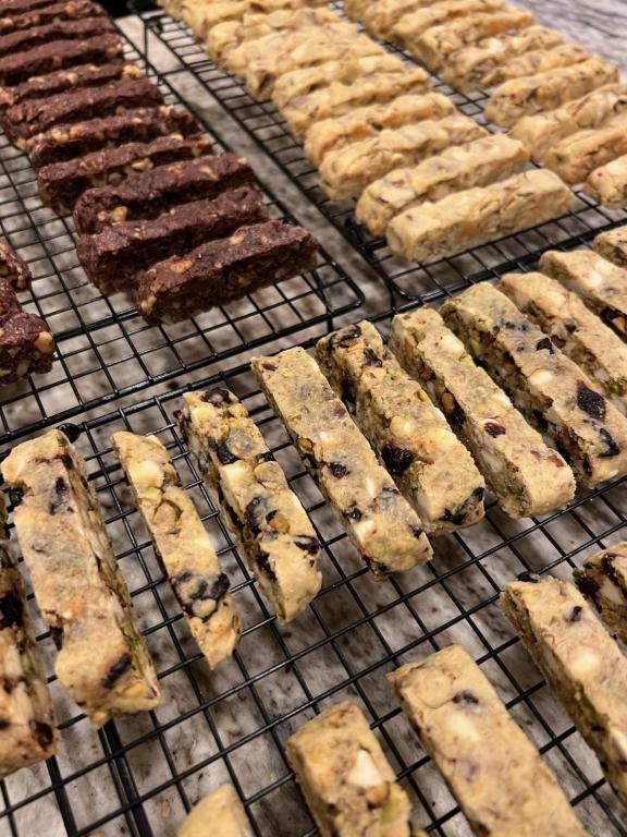 Various flavors of freshly baked biscotti on wire cooling racks