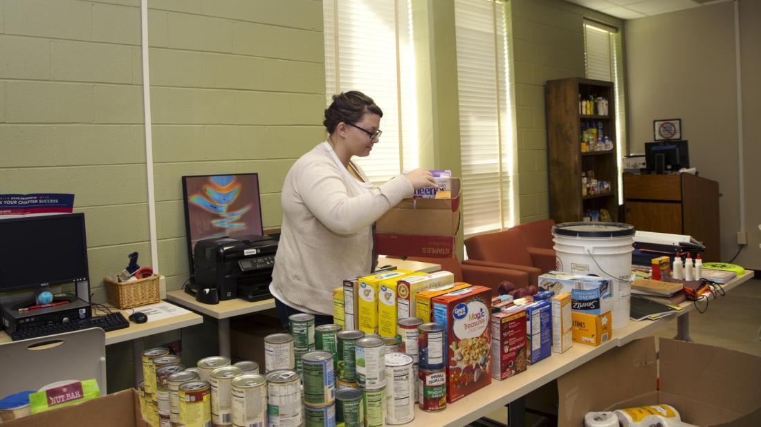 Craven CC student and Phi Theta Kappa member Paige Fike set out donations for the food pantry and supply closet as part of a college-wide effort to assist Craven CC faculty, staff, and students affected by Hurricane Florence.