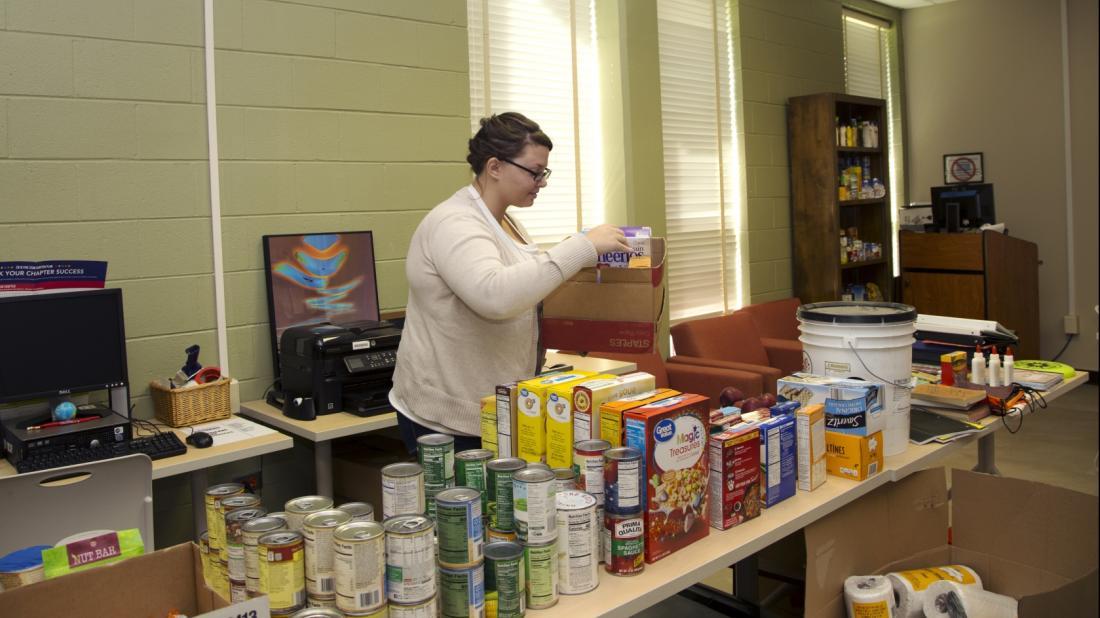 Craven CC student and Phi Theta Kappa member Paige Fike sets out donations for the food pantry and supply closet as part of a college-wide effort to assist Craven CC faculty, staff and students affected by Hurricane Florence.