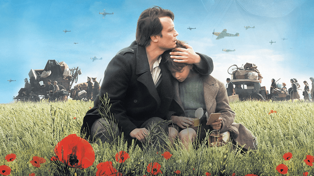 Come What May movie photo of man in red poppy field comforting a child while planes fly overhead