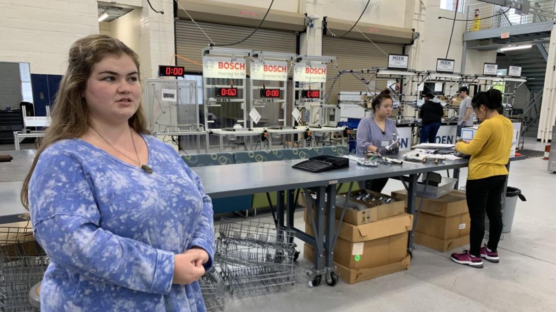 Volt Center instructor Brianna Johnson stands by assembly line by EdNC