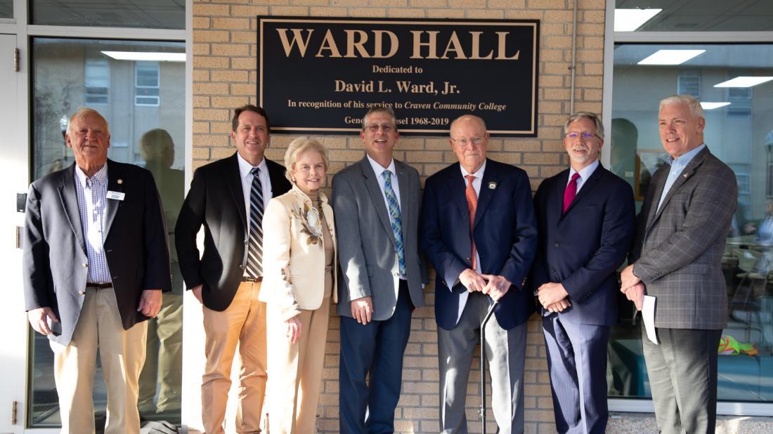 David L. Ward, Jr. is honored with an unveiling of the new signage for Ward Hall during a dedication ceremony on Feb. 21. The longtime Craven CC supporter served as the college's general counsel for over 51 years. Pictured L-R: Craven CC Trustee Bill Taylor, Trustee Chair Whit Whitley, past Trustee Carol Mattocks, Craven CC President Dr. Ray Staats, David Ward, past Craven CC President Scott Ralls, and Trustee Kevin Roberts.