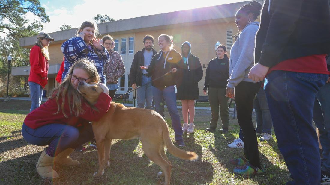 Students in Craven Community College’s Transitions Academy donate dog biscuits they made as part of a community service project. Representatives from the Craven Pamlico Animal Services Center and Craven County Sheriff’s Office Animal Protective Services brought along a furry friend, Nugget, as an official taste tester.