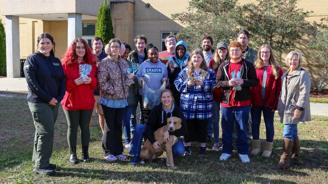 Students in Craven Community College’s Transitions Academy donate dog biscuits they made as part of a community service project. Representatives from the Craven Pamlico Animal Services Center and Craven County Sheriff’s Office Animal Protective Services brought along a furry friend, Nugget, as an official taste tester.