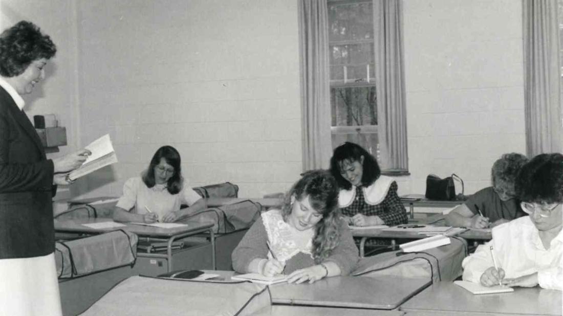 Teacher and students in classroom in 1980s