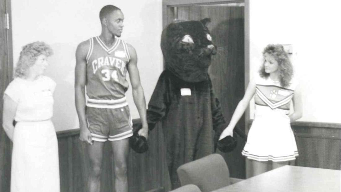 College female worker, male basketball player, black panther mascot, and female cheerleader