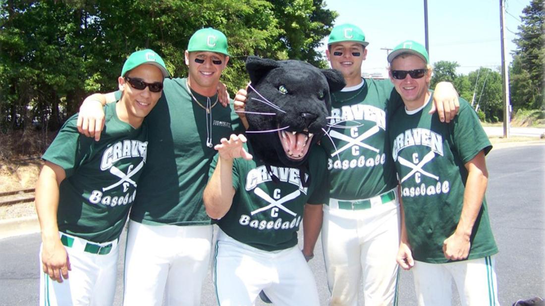 Panthers baseball players pose with old Knight the panther in 2010