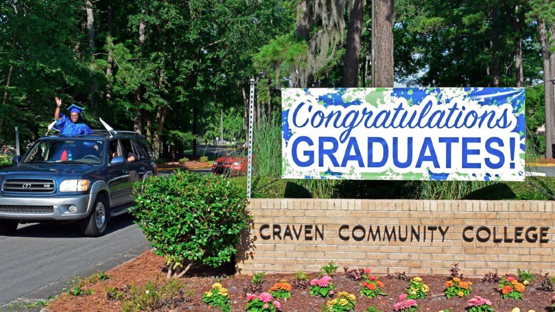 Female graduate participates in drive-thru graduation in 2020