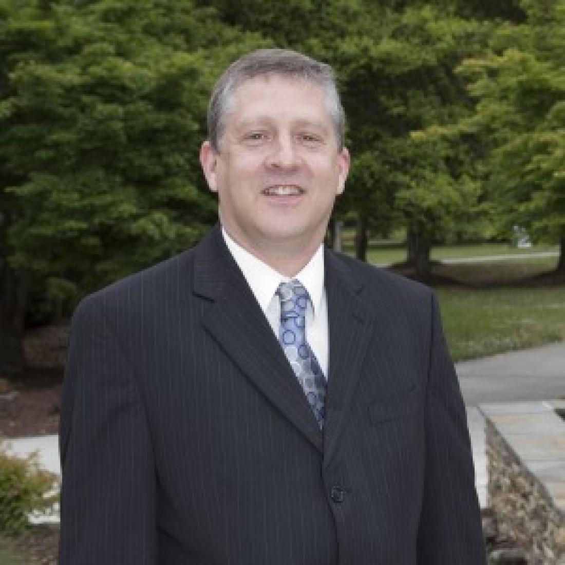 College President Dr. Ray Staats standing outside