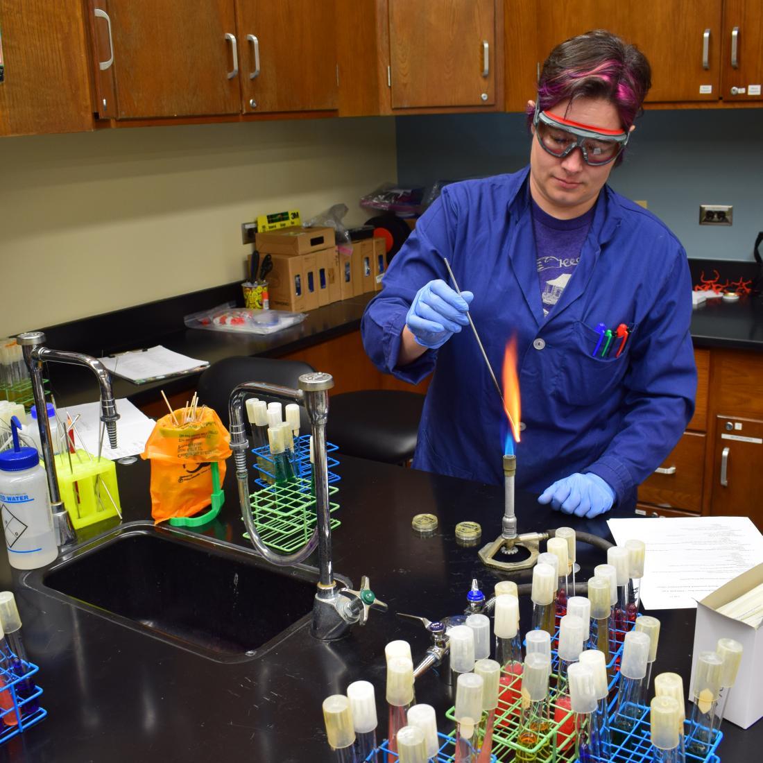 Science teacher does an experiment with high flame on burner