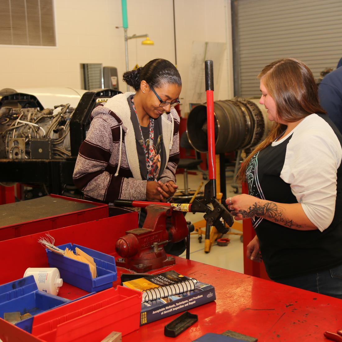 Aviation Systems Technology powerplant students look at parts