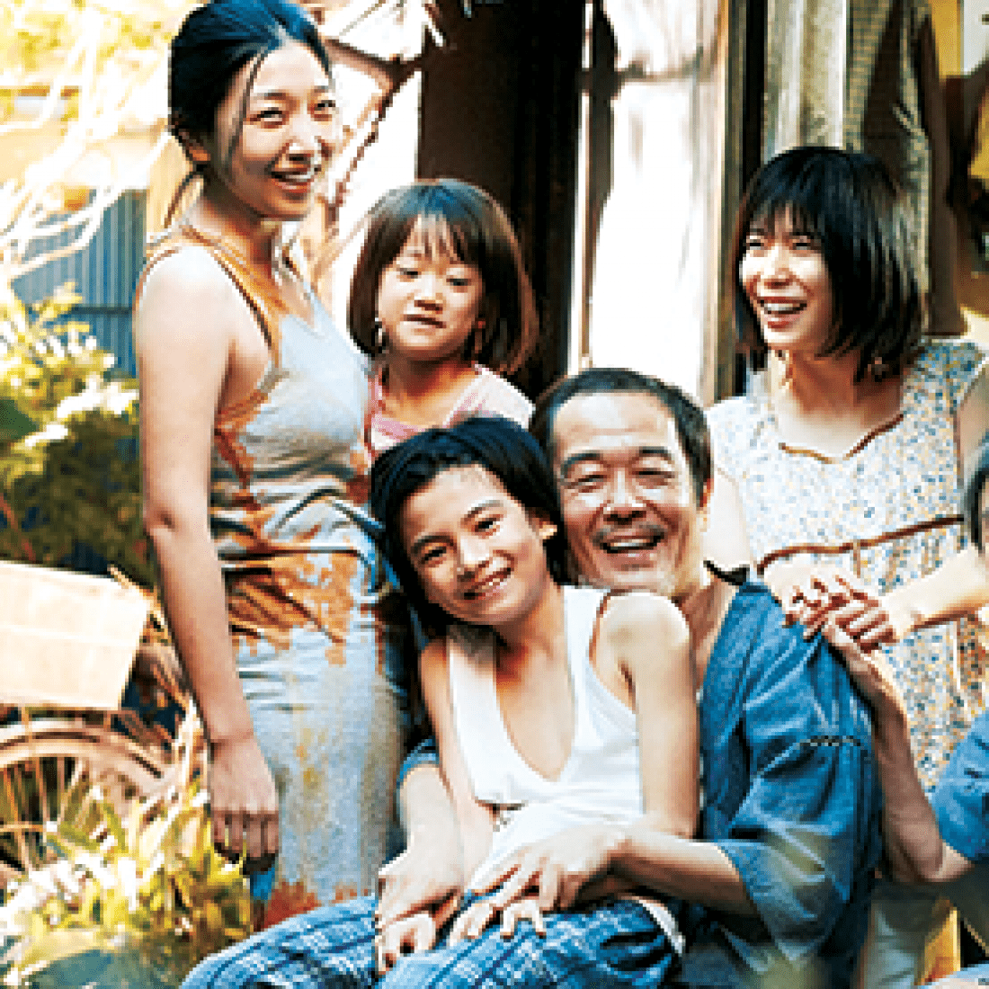 Shoplifters film photo of smiling Asian family