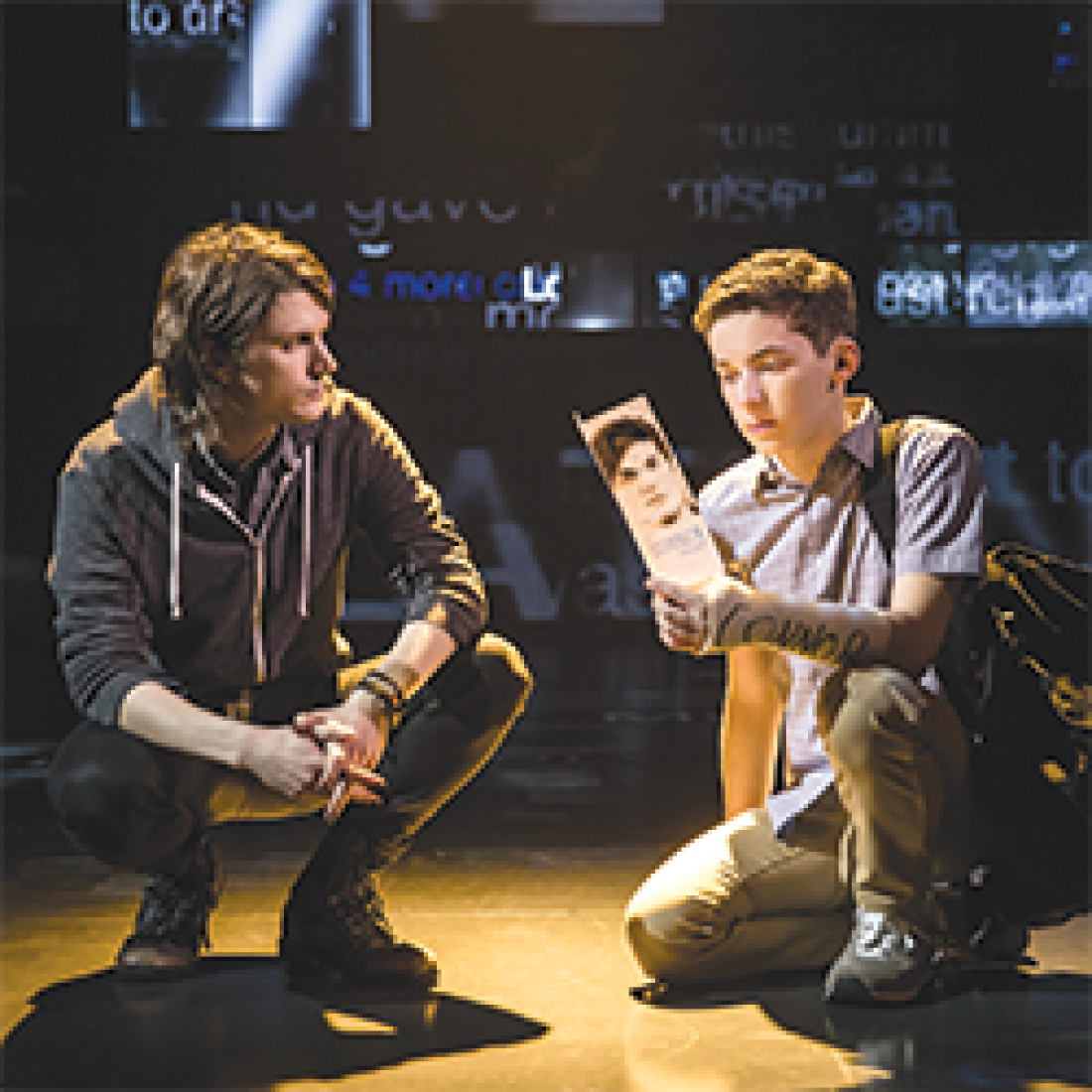 Two boys kneeling and talking in Dear Evan Hansen musical