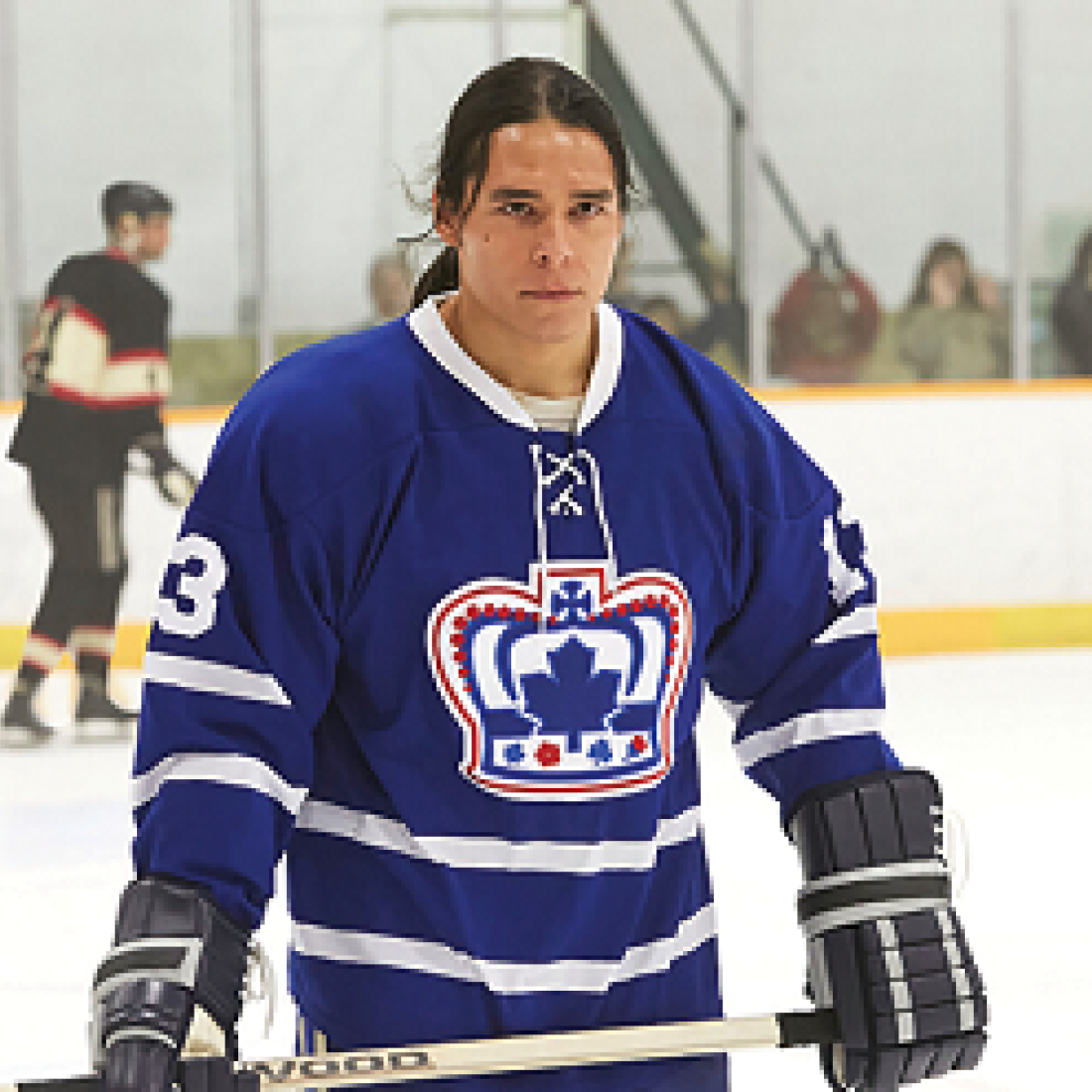 Indian Horse movie promo of young adult male hockey player in a rink
