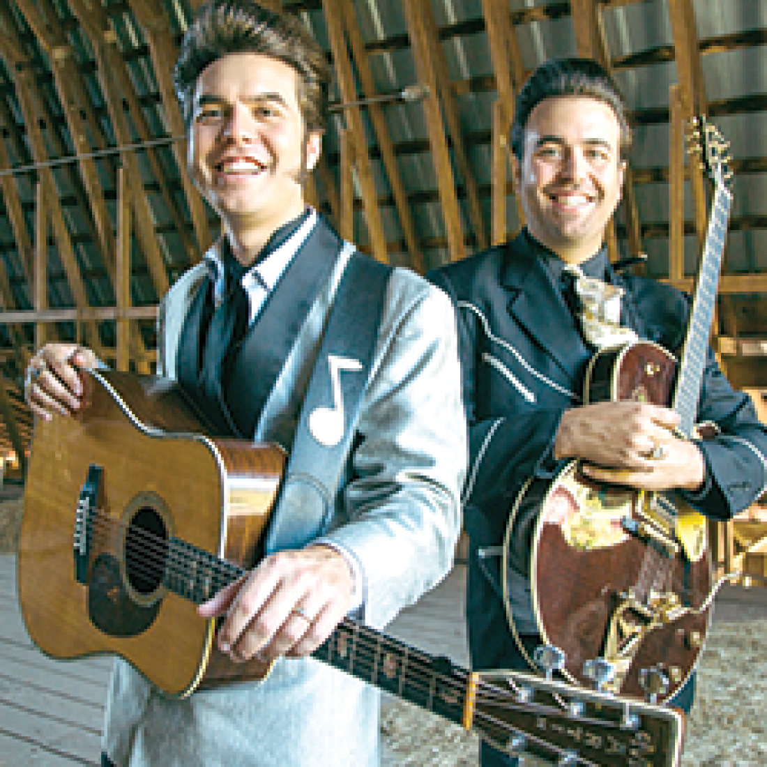 Two men in suits holding guitars