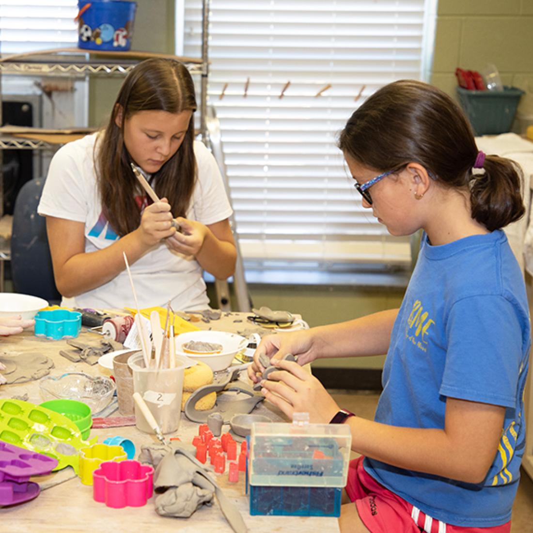 Three girls create crafts
