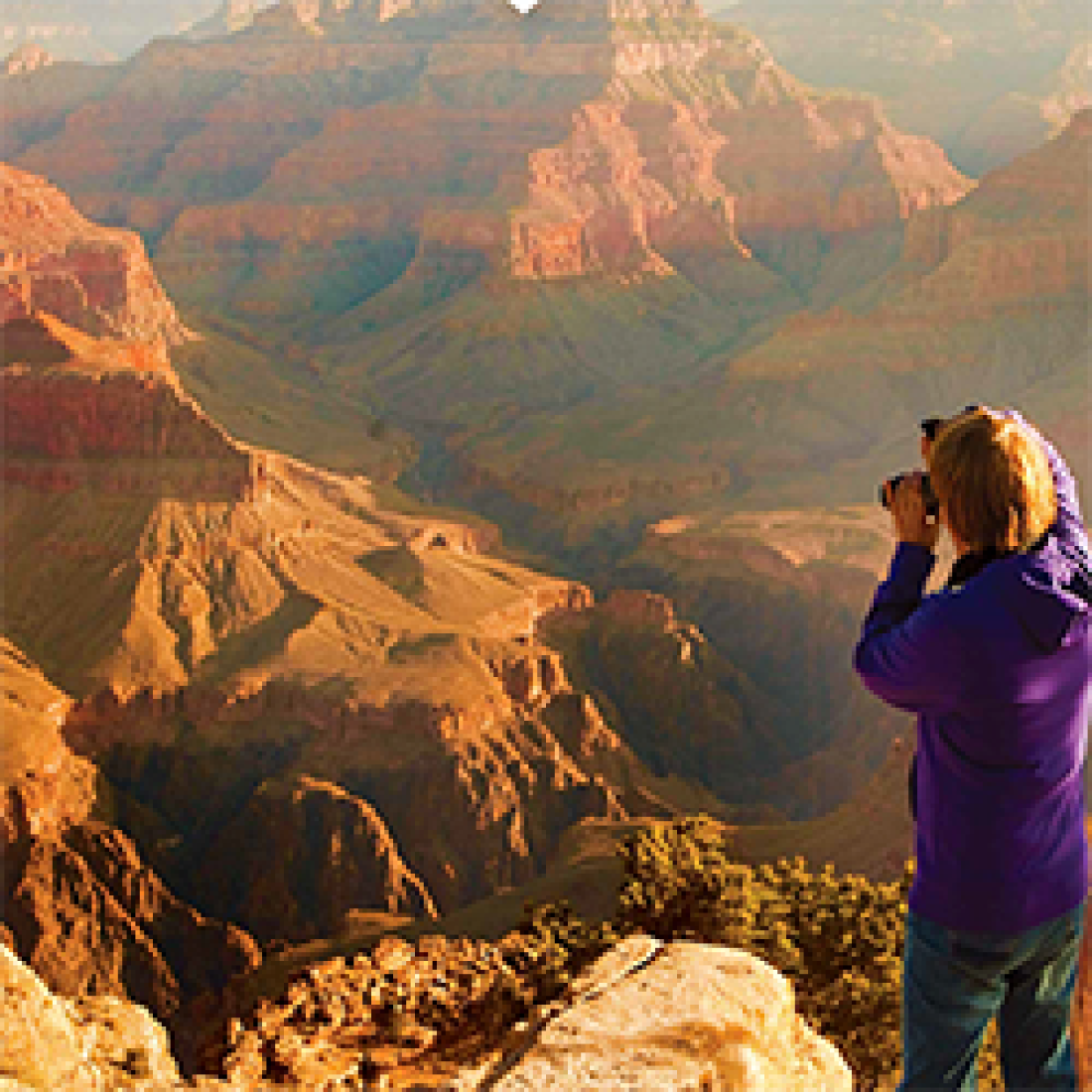 Woman taking a photo of the Grand Canyon