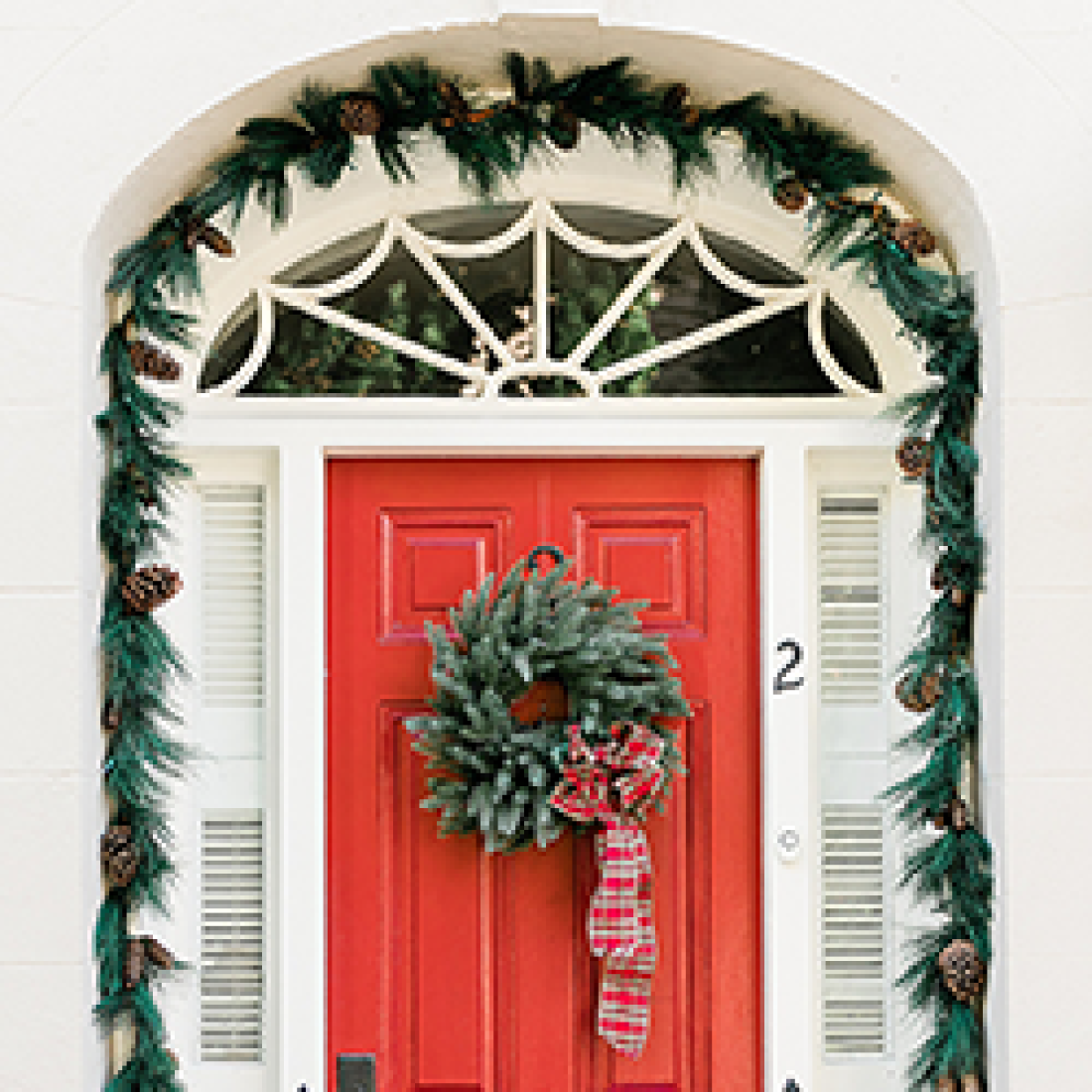 Red door decorated for Christmas