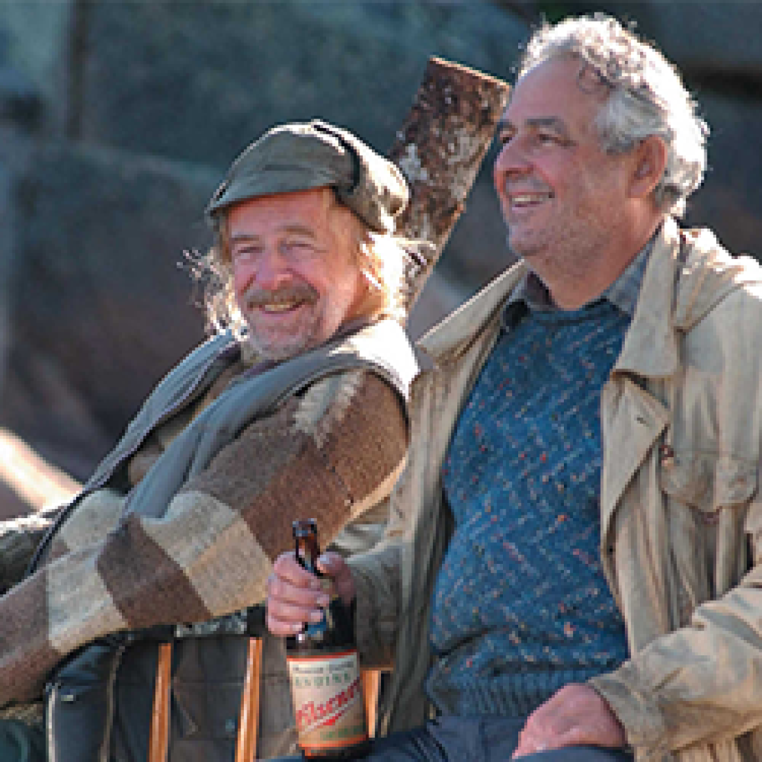 Two older men smiling goofily in still from the film Seducing Dr. Lewis