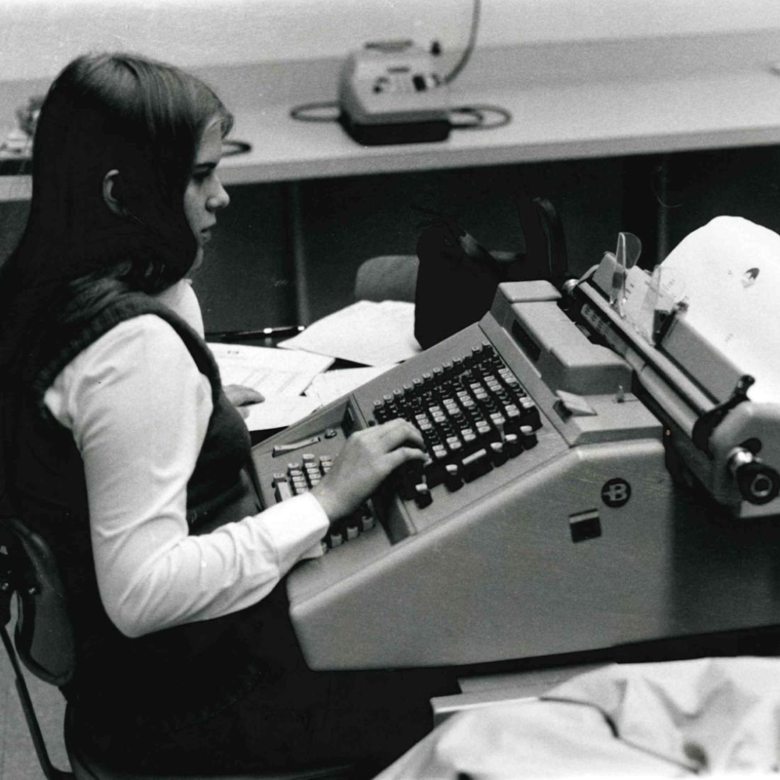 Female using typewriter in 1970s