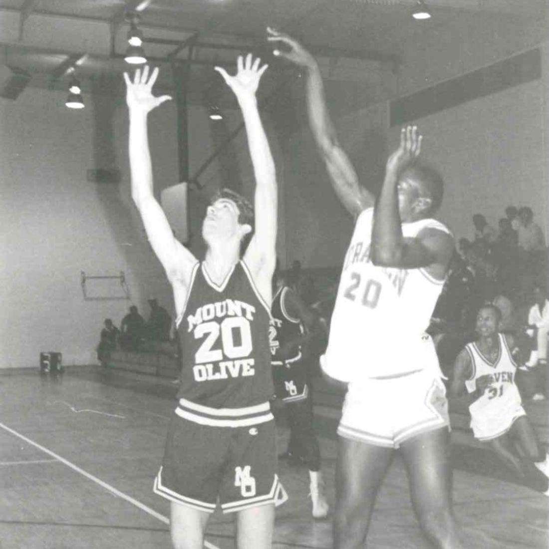 Two male basketball players during a game in 1983