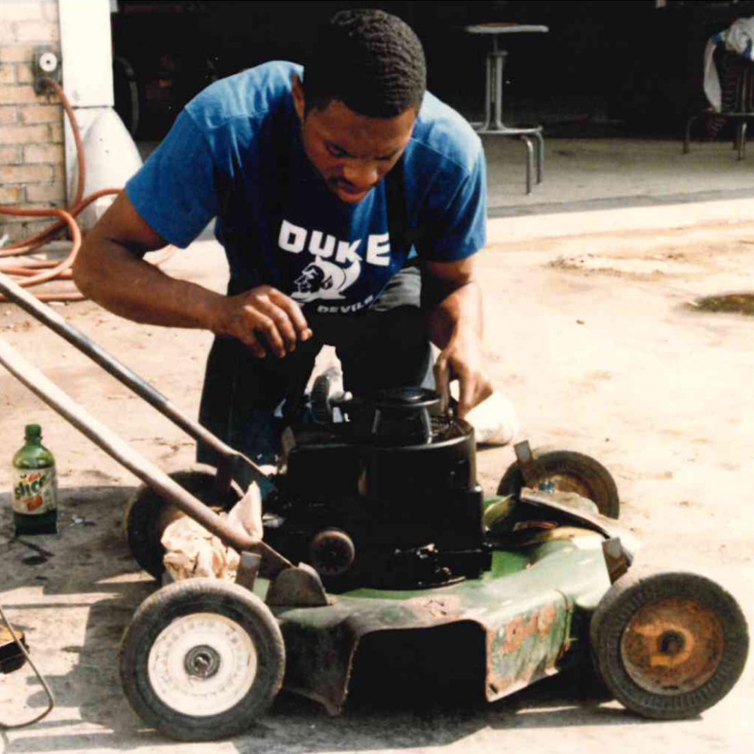 Male student working on lawnmower in 1986