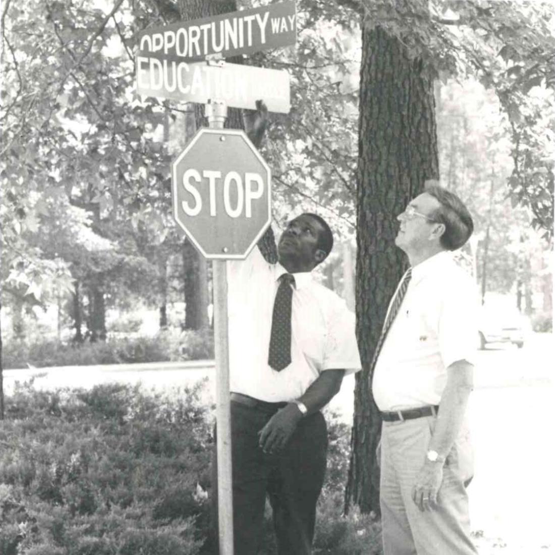 Male employee and Dr. Brock looking at street signs in 1988 