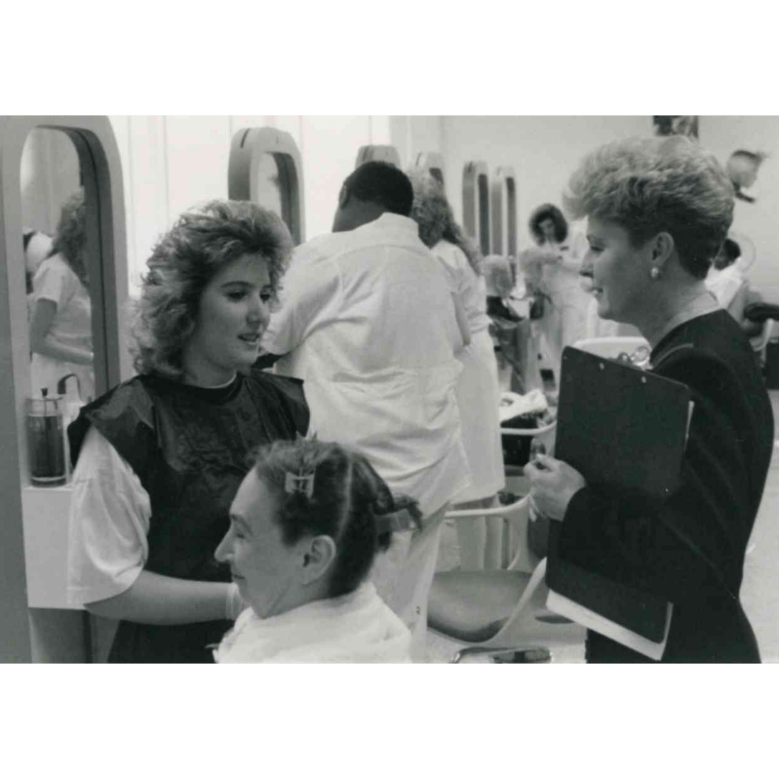 Cosmetology student and instructor with customer in 1990