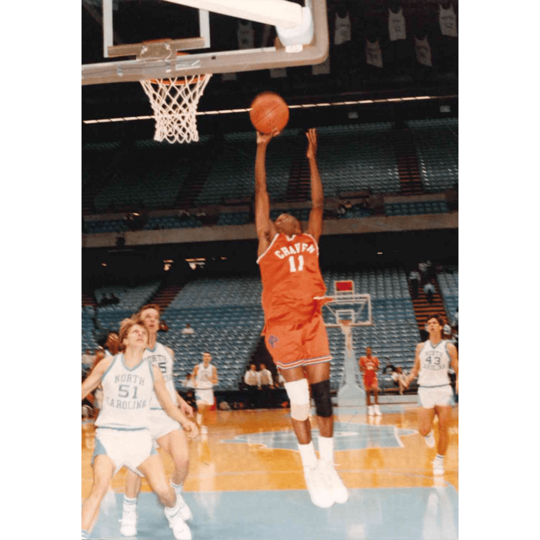 Craven basketball player scoring on two UNC Chapel Hill players in 1990s