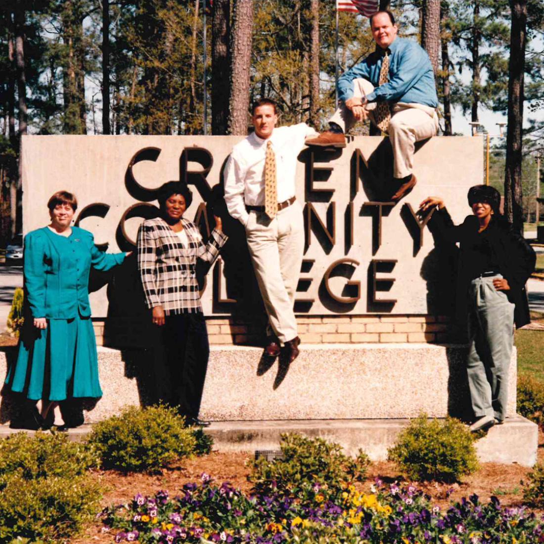 Student Services staff standing by Craven sign in 1996