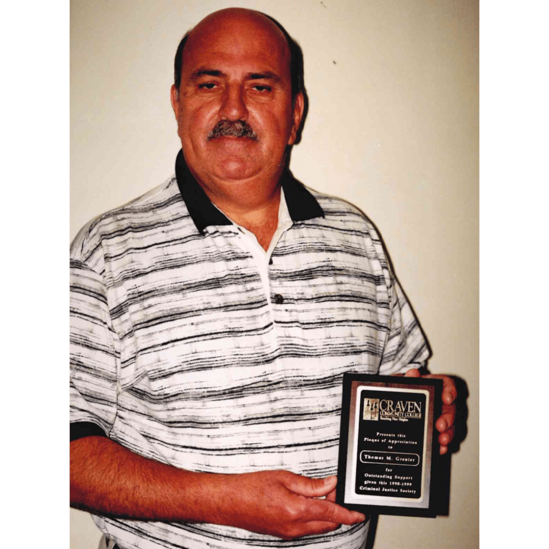 Man with award plaque in 1999