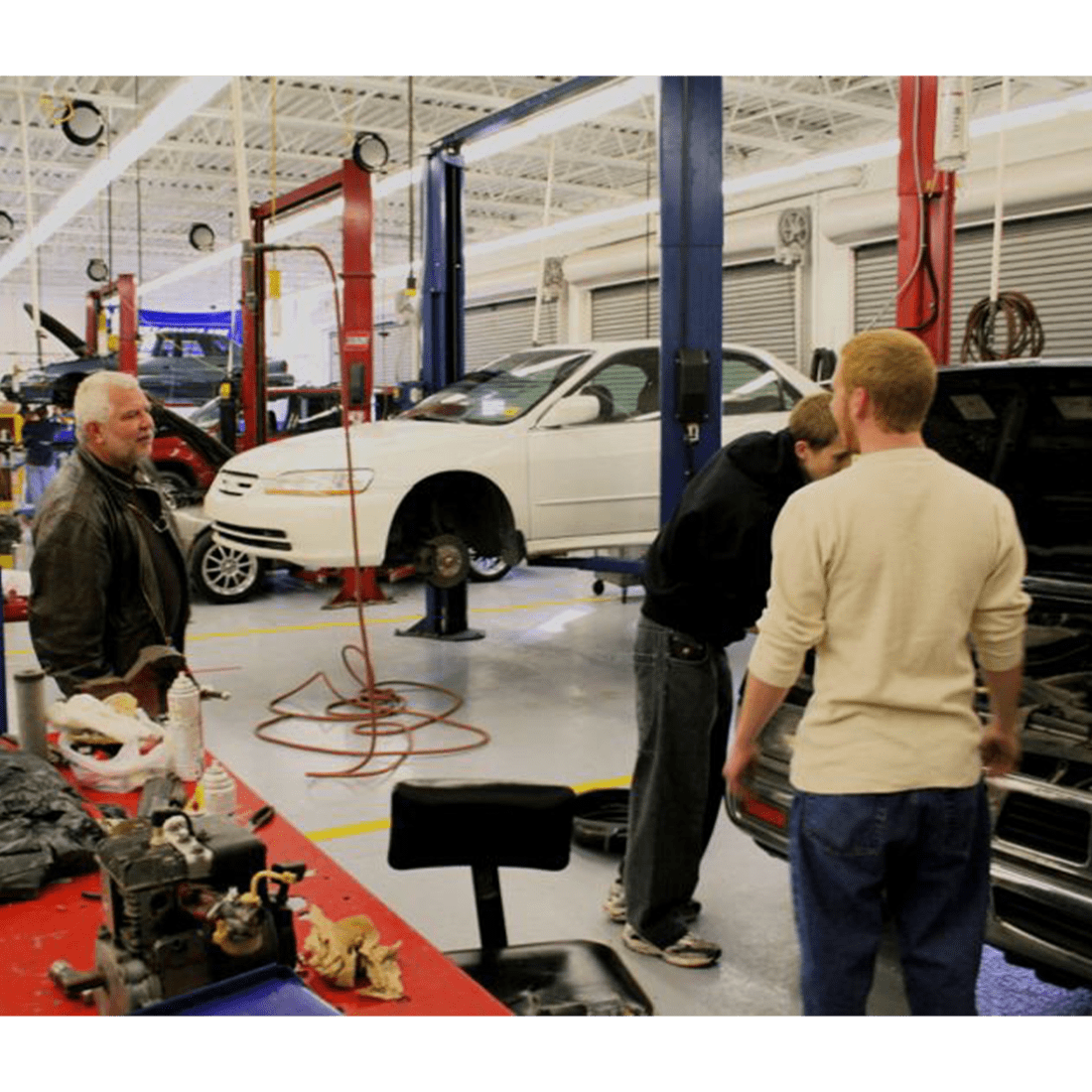 Instructor and students in the auto bay in 2000s