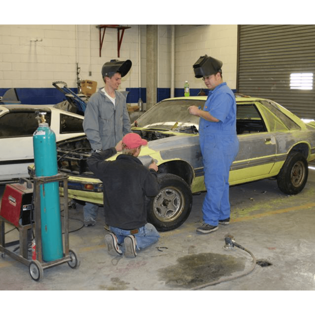 Three male automotive students in 2000s