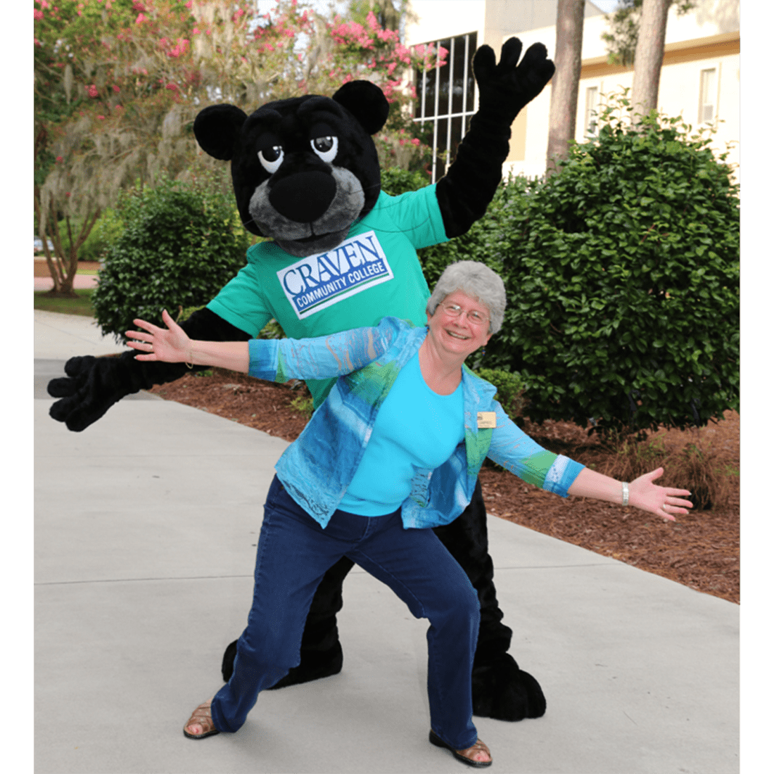 Former library director Cathy Campbell and Knight the Panther in 2010s