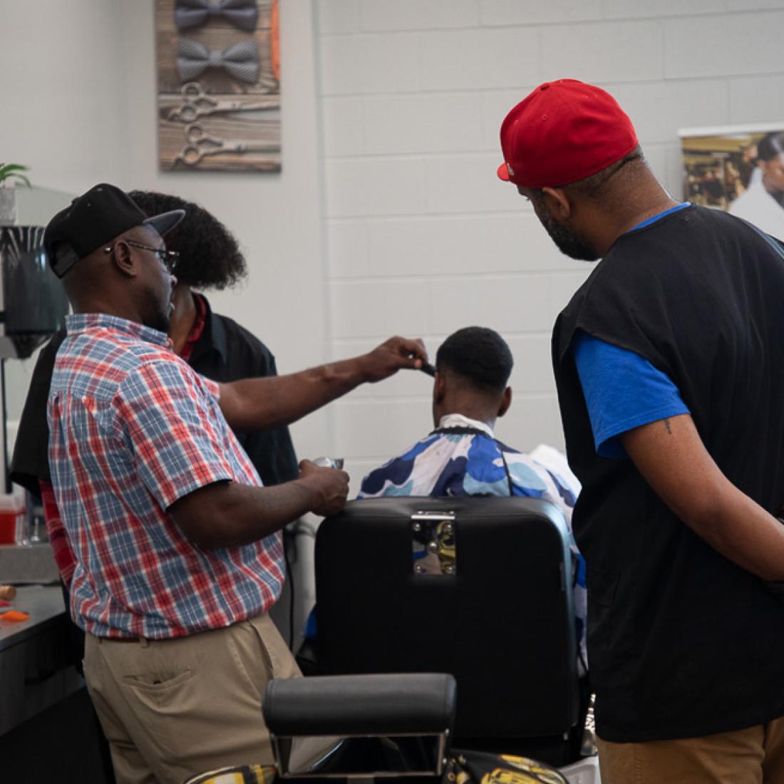 Barbering instructor and students in 2010s