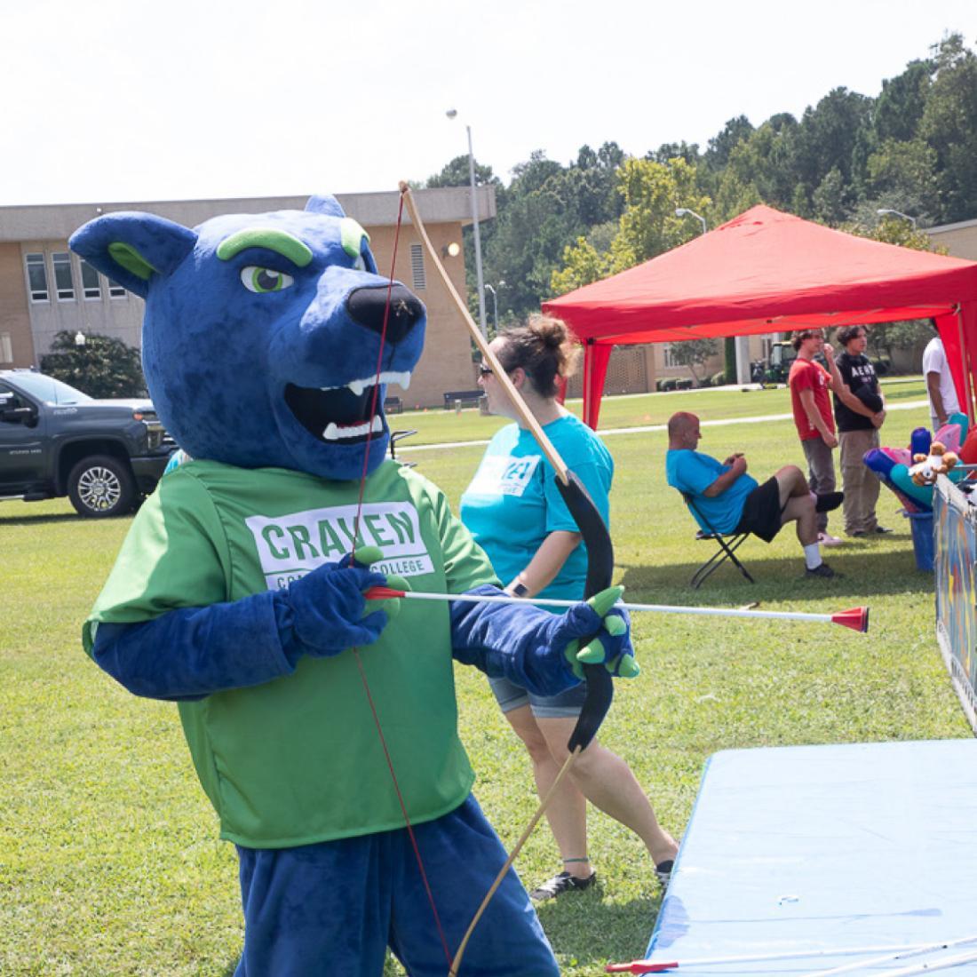 Blaze the Panther mascot holds a bow and plunger arrow during PantherFest in 2023