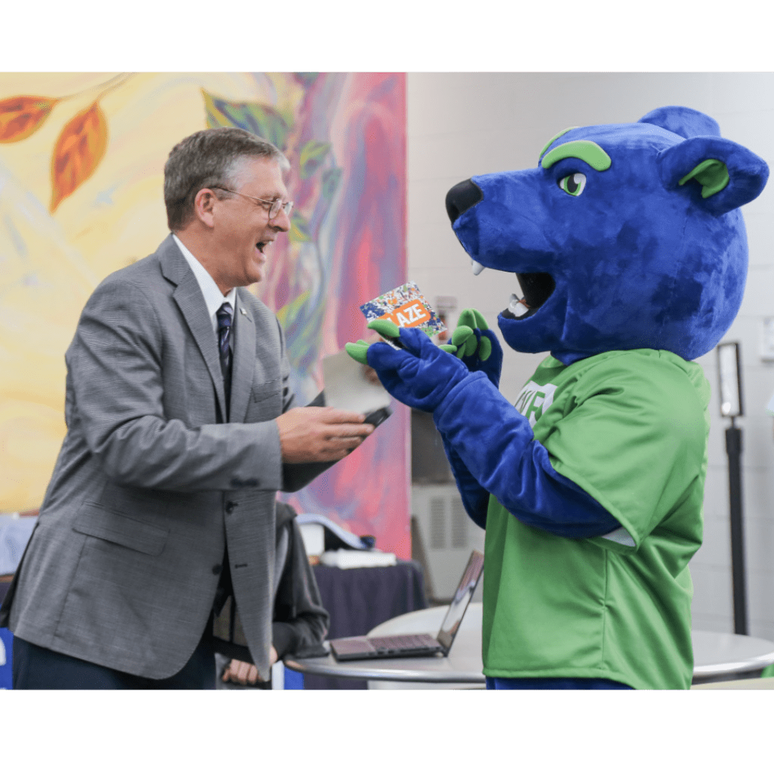 Dr. Ray Staats finds out the new mascot's name with Blaze the Panther in 2023