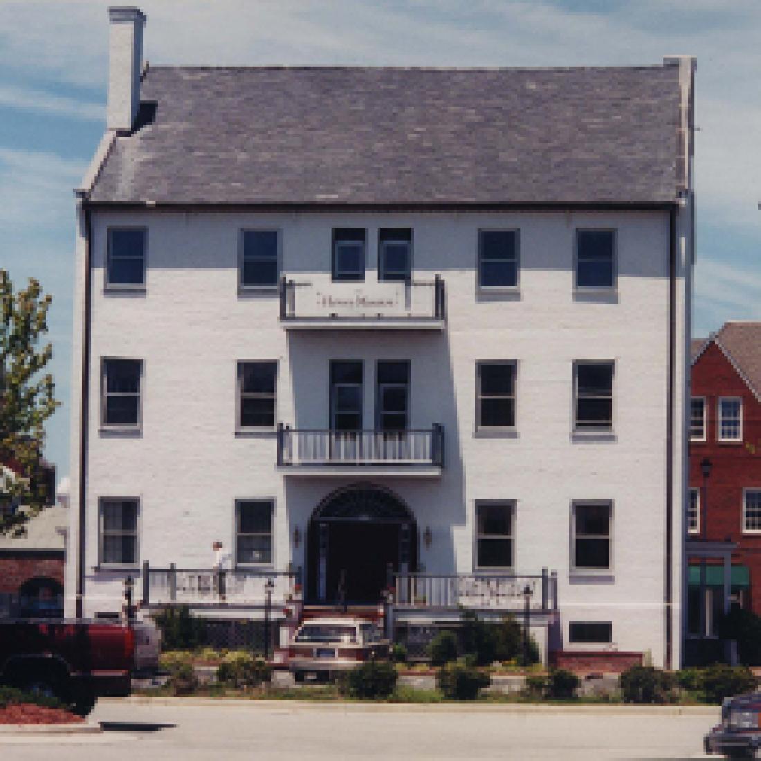 Exterior of white, three-story Harvey Mansion in 1980s or 1990s