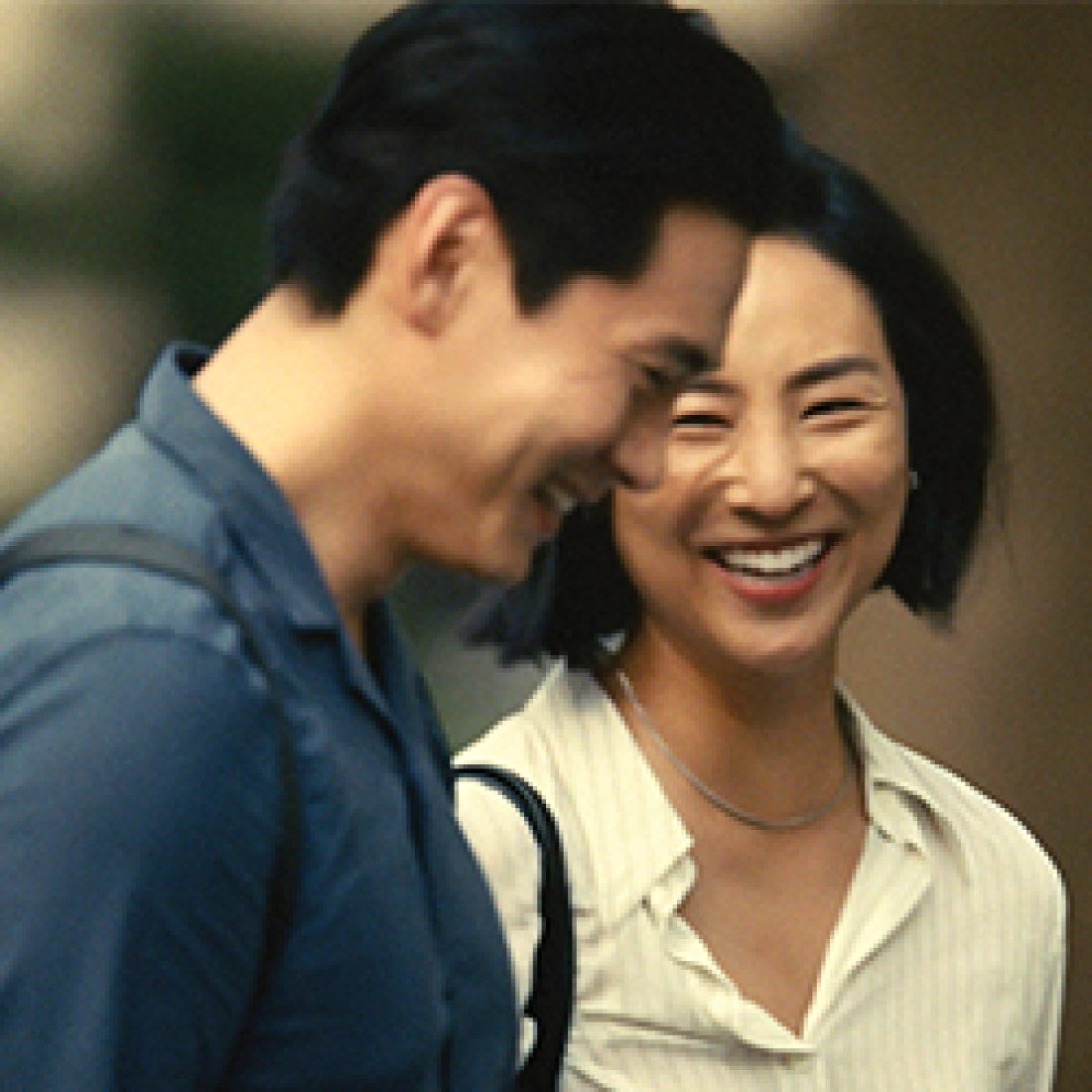 Asian male and female laughing together