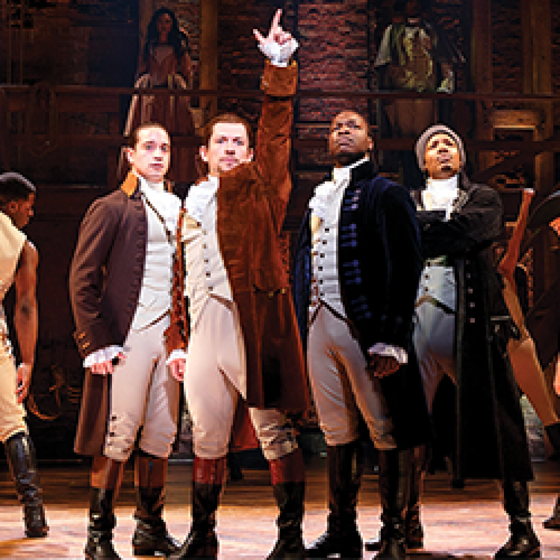 Actors dressed in fancy nineteenth-century attire for the Hamilton musical