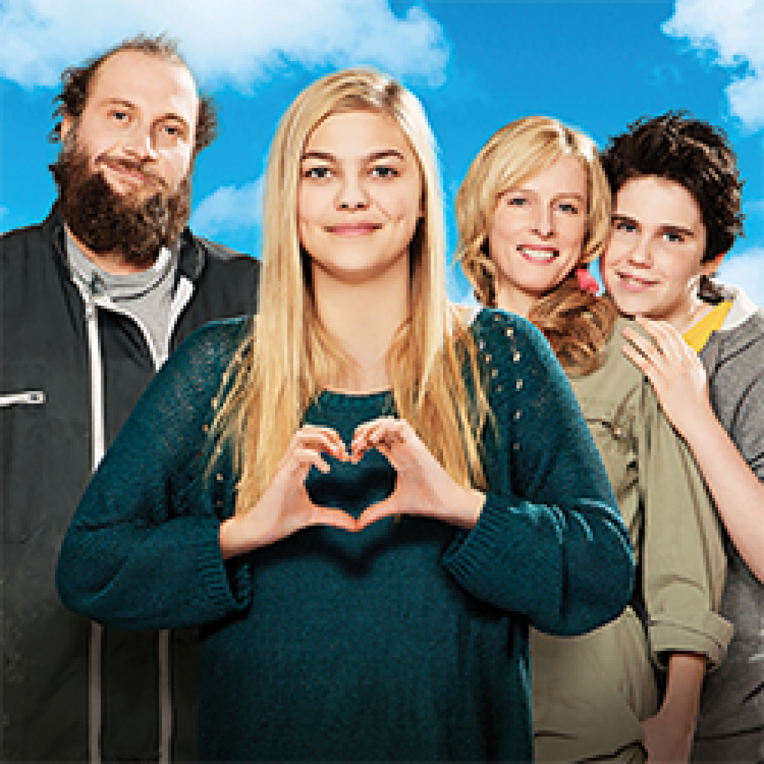 Teenaged girl with long blonde hair signs a heart while standing with her two parents and brother