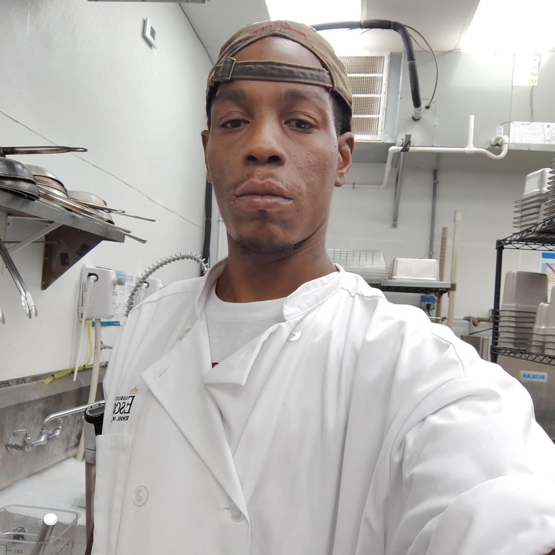 Chef stands in kitchen