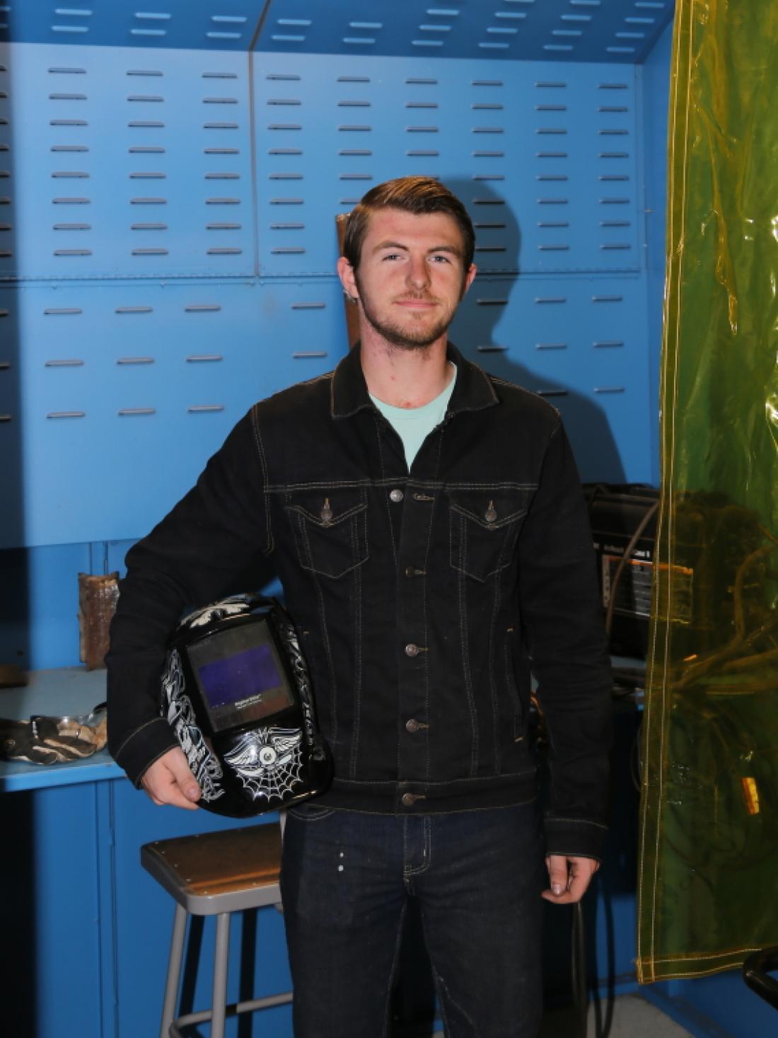 Craven Community College and Early College EAST student Zack Farnham stands in his welding booth in the college’s welding department. (Photo by Meredith Laskovics)