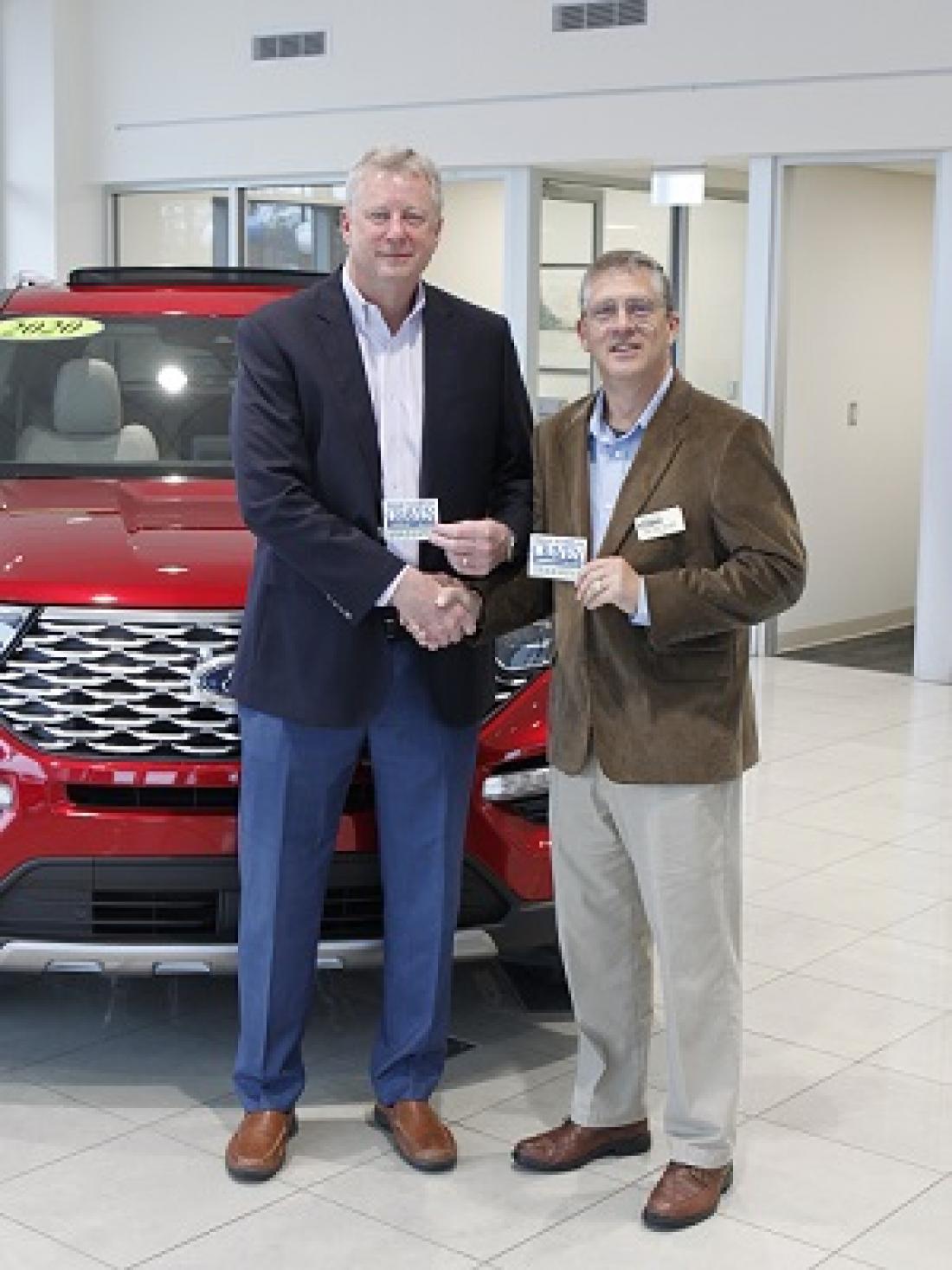 Craven CC President Ray Staats, right, welcomes Steve Cella of Cella Ford into the Panther Partnership.