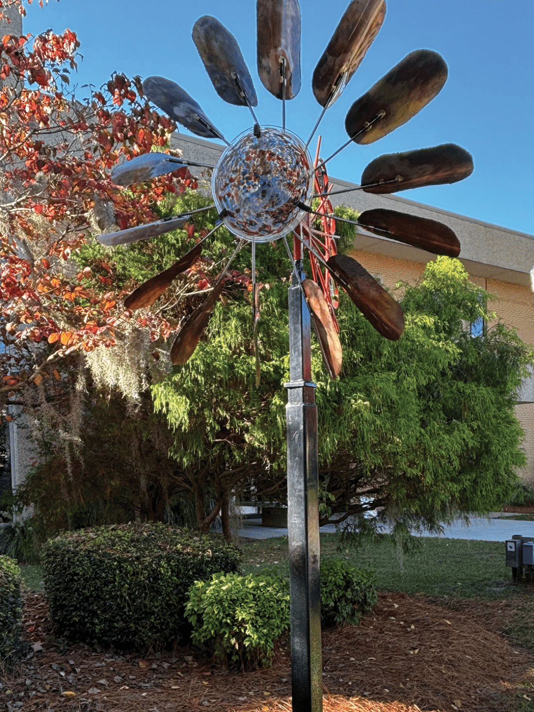Metal and glass sculpture resembling a windmill